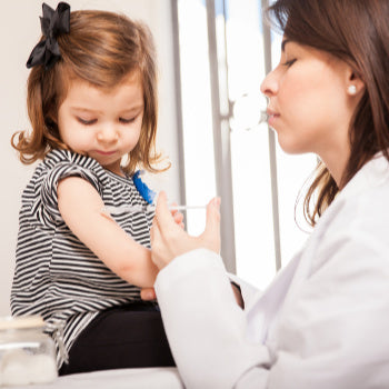 doctor giving a shot to prevent the flu in infants