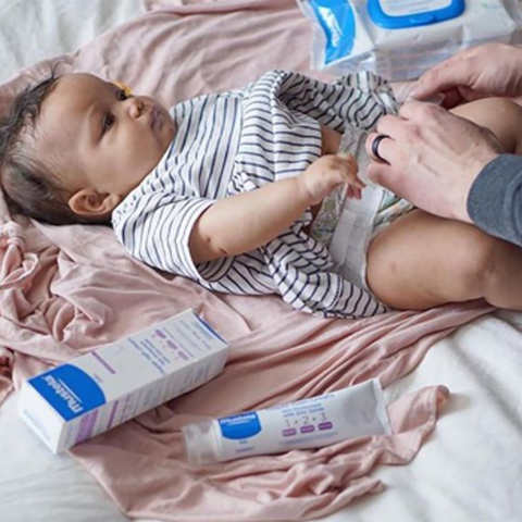 changing diaper with Mustela products