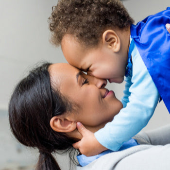 Happy mom and child snuggling faces