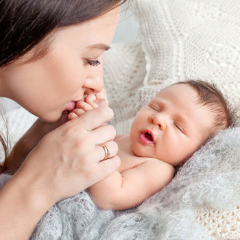 mom comforting newborn