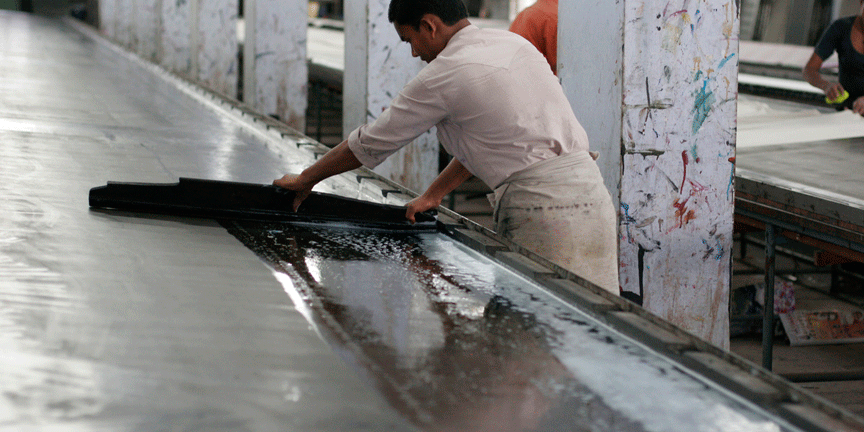 Artisans washing the hot wax tables 