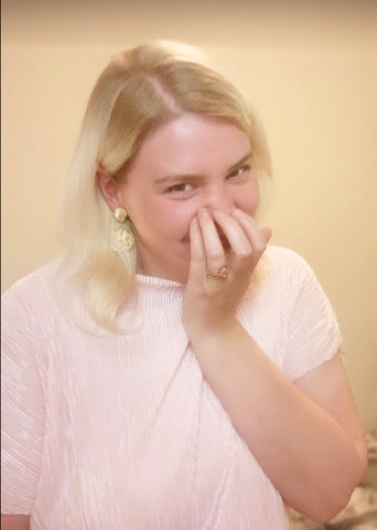 girl laughing and covering face with hand