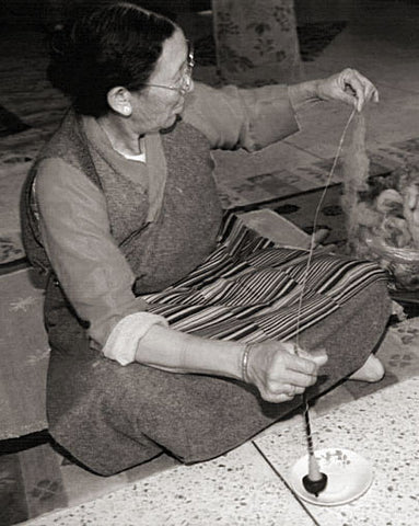 hand spinning wool for a handmade rug in nepal