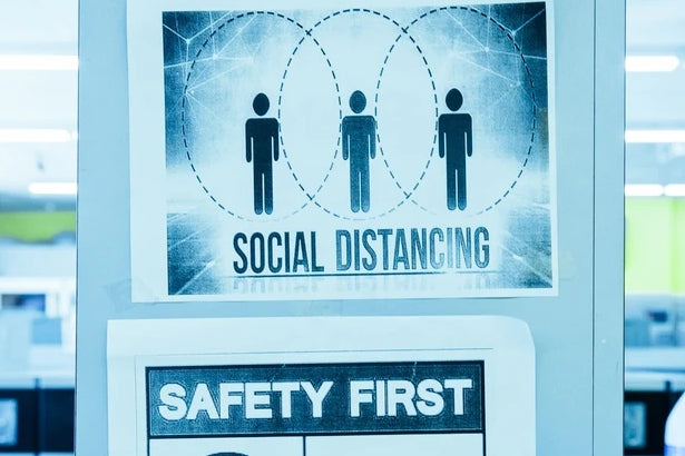 A sign saying social distancing