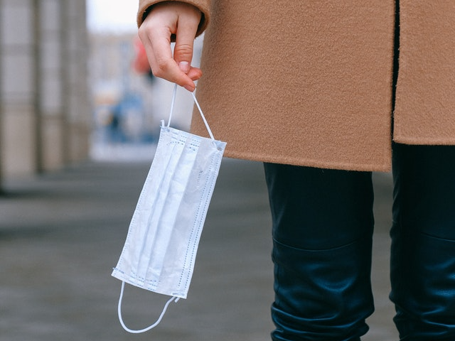 Woman holding face mask