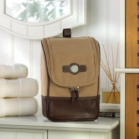 A brown travel bag in several shades of brown with personalized initials on the front