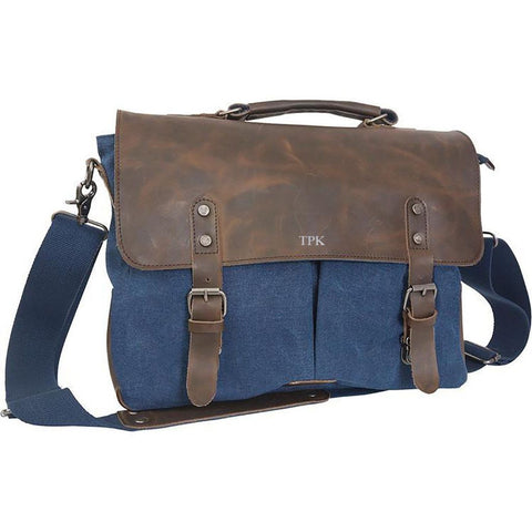 A blue travel duffle bag with a brown leather flap over the top with the initials TPK on the top