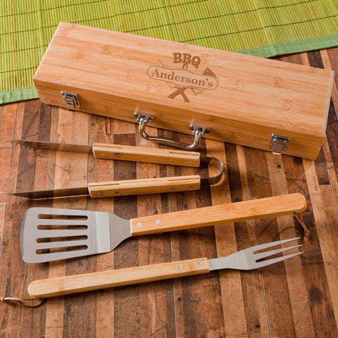 A wooden BBQ grill set that includes tongs, fork, spatula and carrying case