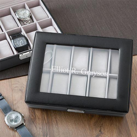 A black leather watch box that says Elliot R Grayson on the cover
