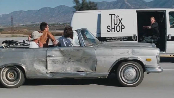 The Tux Shop delivering a tux while driving in the movie The Hangover