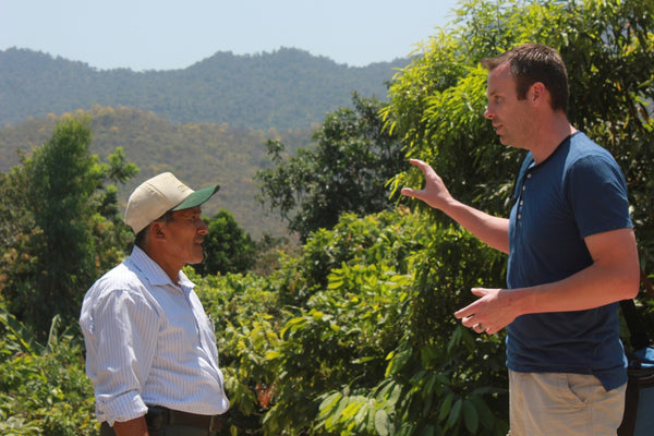 chocolate maker sharing information with cacao farmer