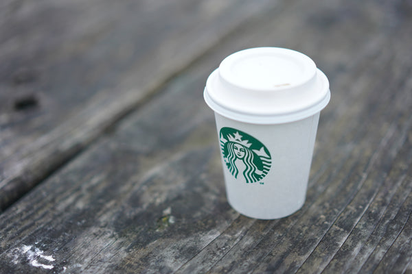 Starbucks cup on wooden plank