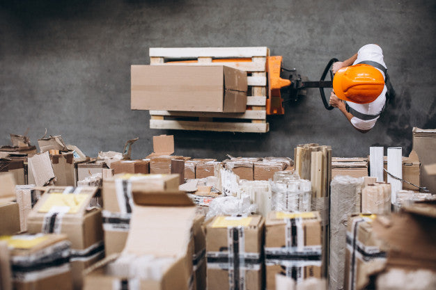 A warehouse worker stacking packages for FBM shipping