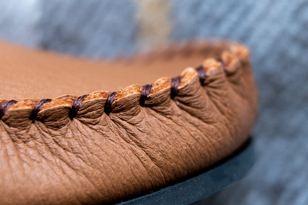 hand-stitching on moccasins close up