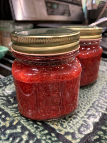 Strawberry Rhubarb Jam Recipe. Jam in clear glass mason jars with gold metal lids. Locally made jam with organic sugar and fresh produce.