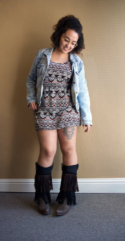 brunette woman wearing black print dress and black fringed cowboy boot covers