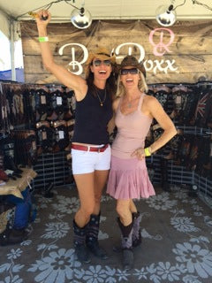 two women posing wearing cowgirl boots with cowgirl boot covers