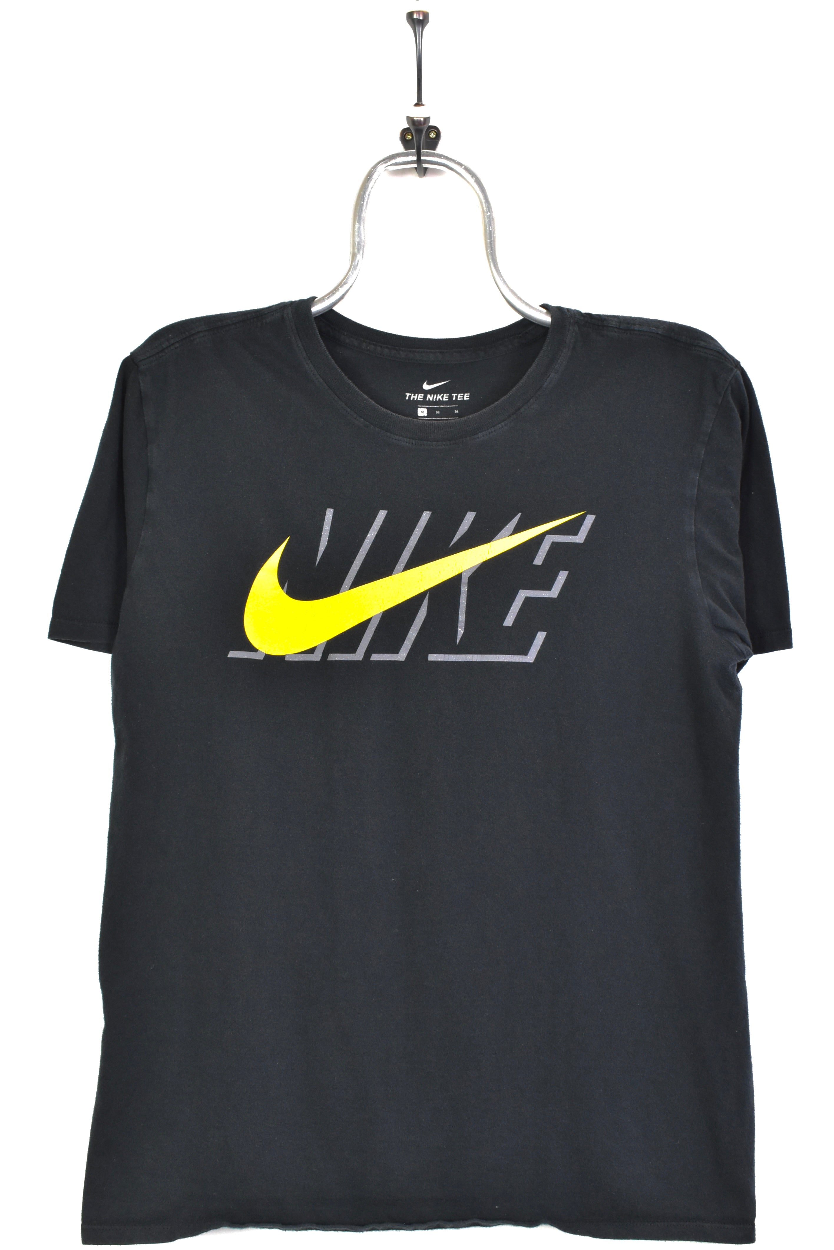 black nike shirt with yellow swoosh