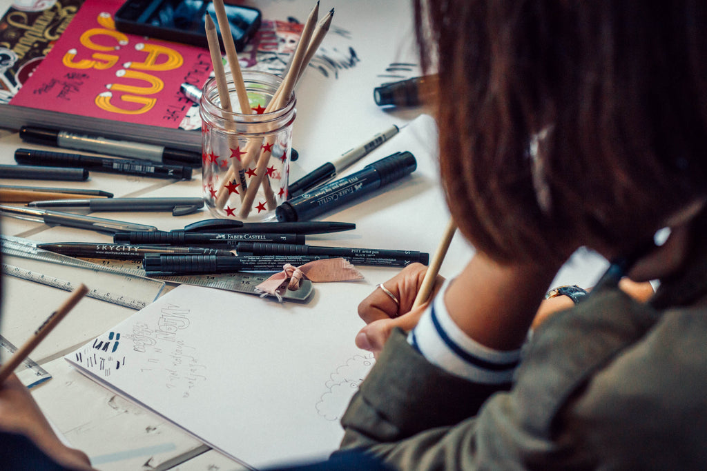 Someone drawing pictures with their FRANK pencils at the FRANK Drawing Club