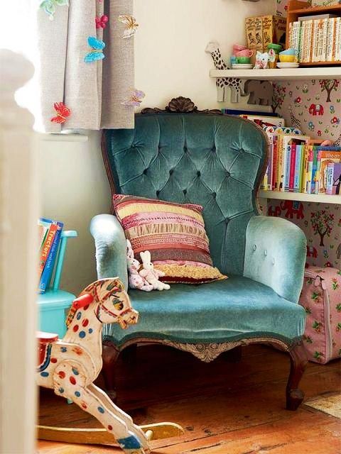 blue tufted chair in girls bedroom reading nook