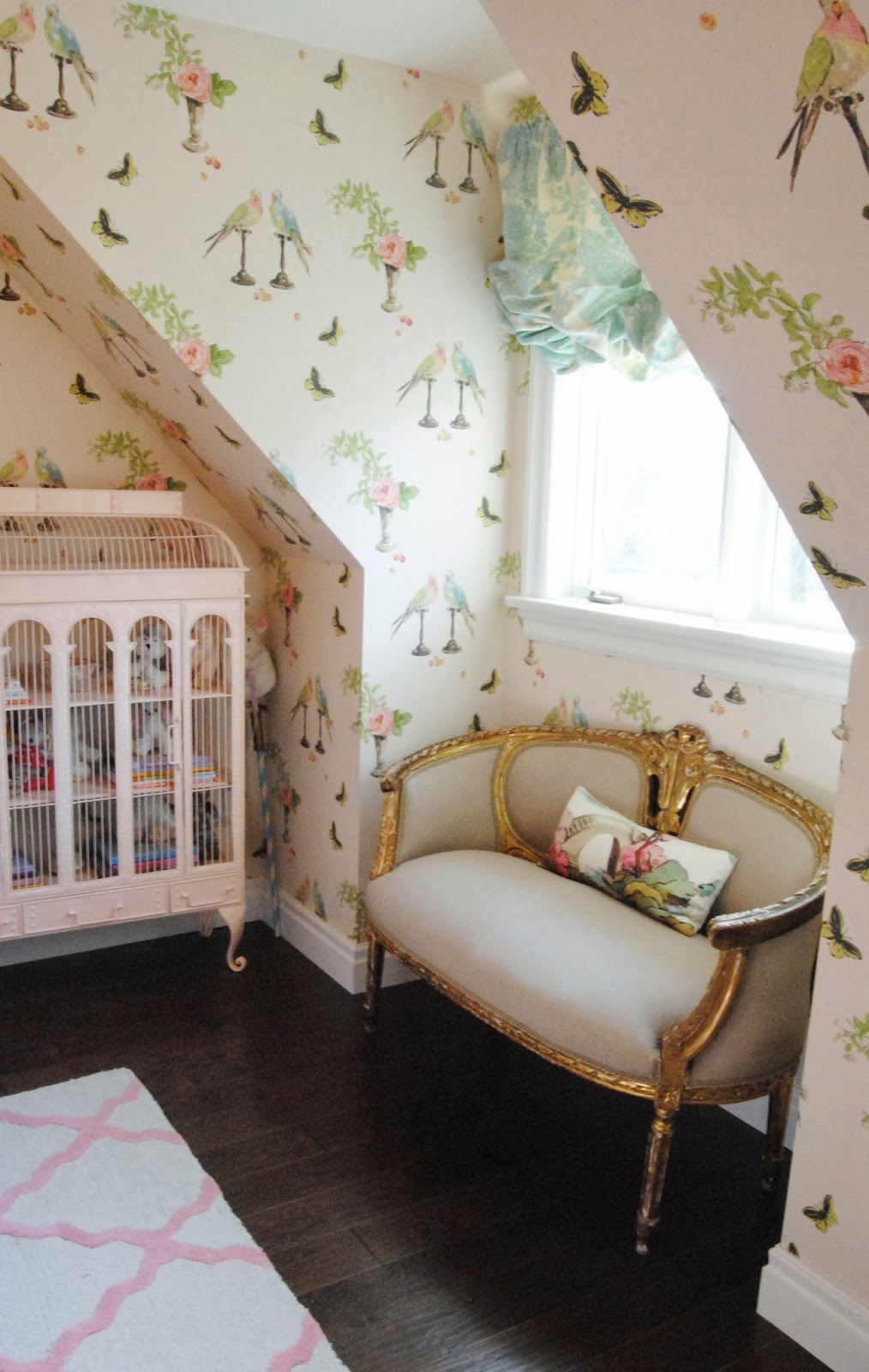 girls room gilt settee in window alcove with bird cage