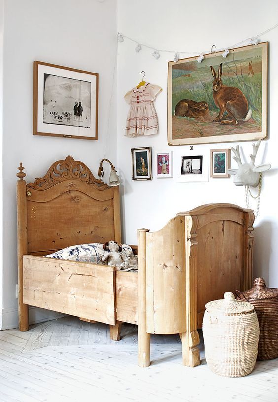 mixed artwork in traditional girls bedroom with antique wooden bed