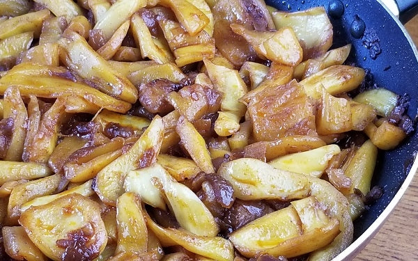 Once the jackfruit starts to heat up, start breaking the pieces apart in such a way to resemble pulled pork.