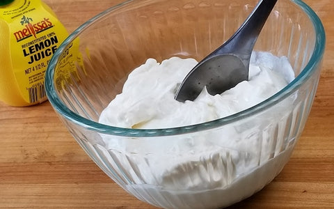 Whip together the cream cheese, sour cream and lemon juice in a small bowl.