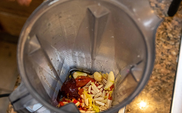 Add the almonds, vinegar, water, garlic, chile, and lemon peel to the diced pepper and process until smooth.