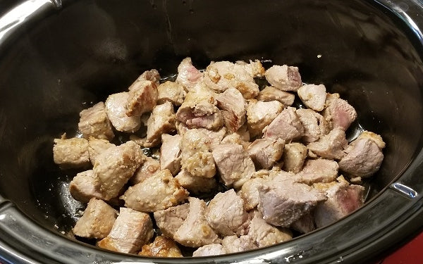 Cut the tenderloin into bite-sized chunks, season with salt and pepper, and then dredge in flour. 
