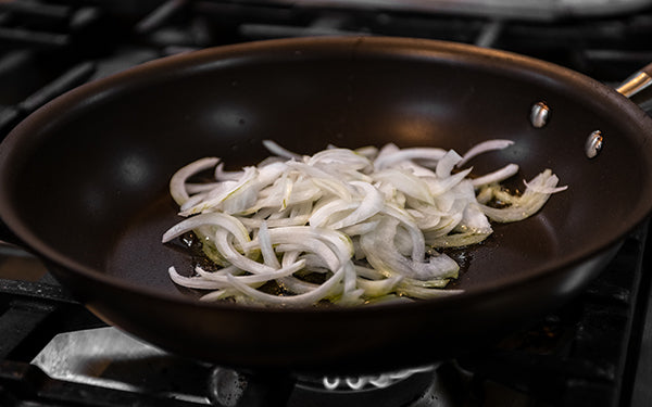 In a large sauté pan, cook the onion in 2 tablespoons of vegetable oil. 