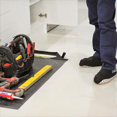Plumber using a TIDY TRADIE Work Mat and Cleanboot covers on the job.