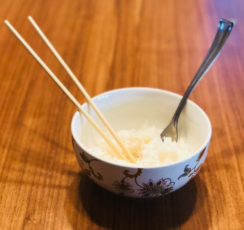 chopsticks and fork in bowl