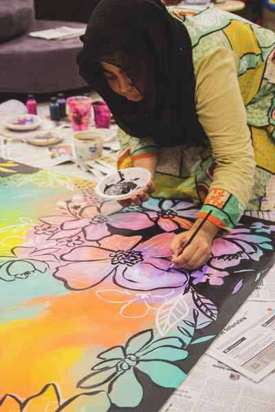 artist painting flower on floor