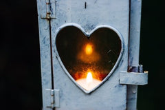 single candle in heart door