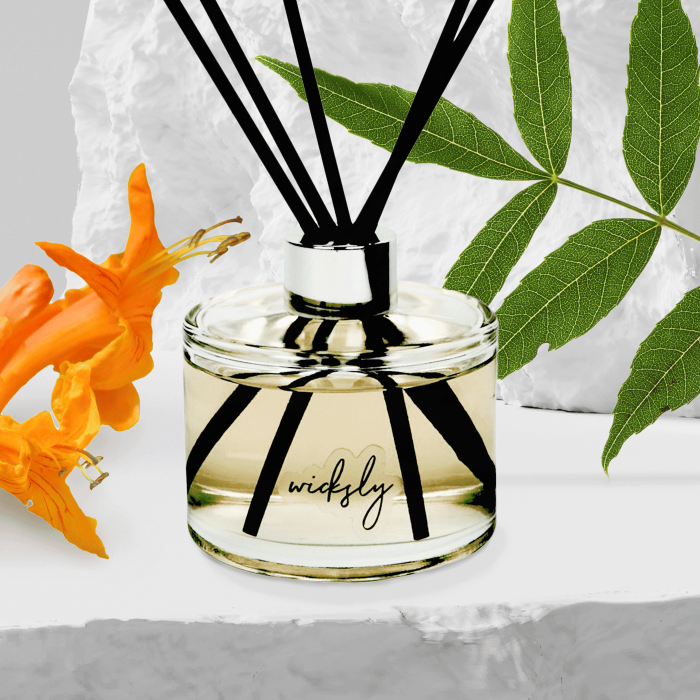 Moonstone Scented round 250 ml Reed Diffuser in clear glass with Wicksly Logo, silver collar, and 5 black reeds