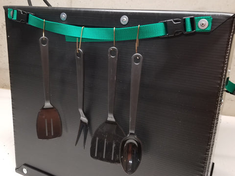 The Chuck Box Paper Towel holder, holding cooking utensils 