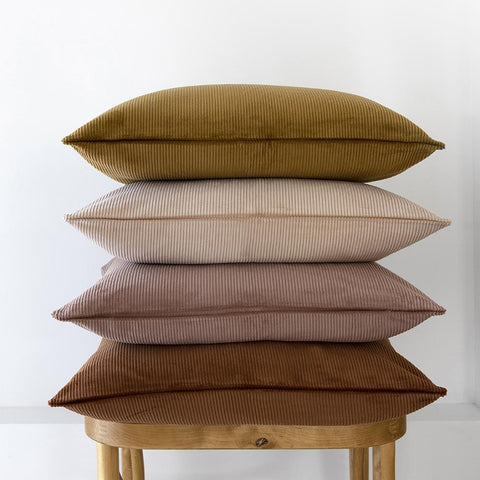 Beautiful stack of Bambury corduroy cushions in earthy colour tones