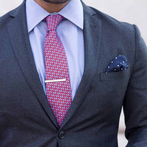 Printed Silk Red and Blue Tie against a Blue Shirt