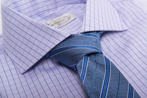 Blue Repp Striped Tie against a checkered shirt