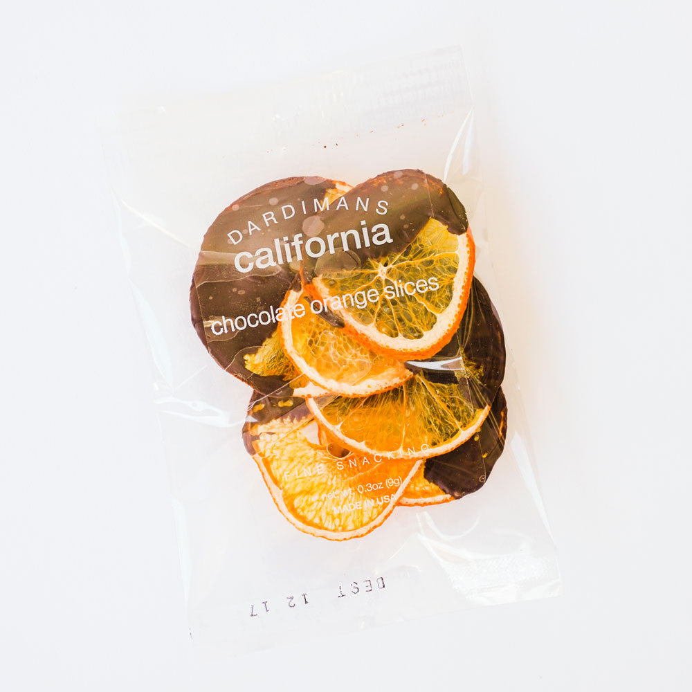 Small plastic pouch with dried oranges, half dipped in chocolate