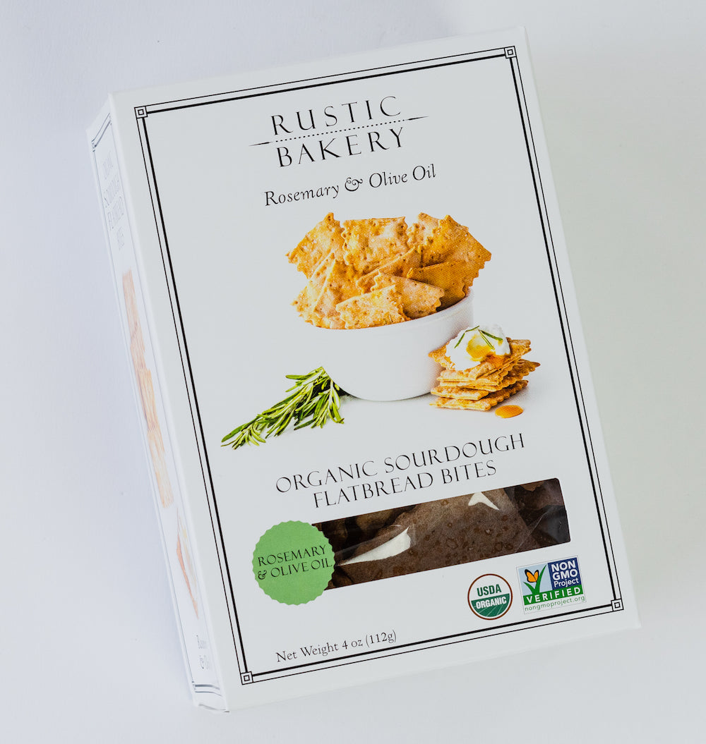 A box of sourdough bites with a picture of the crisps and some rosemary on the front