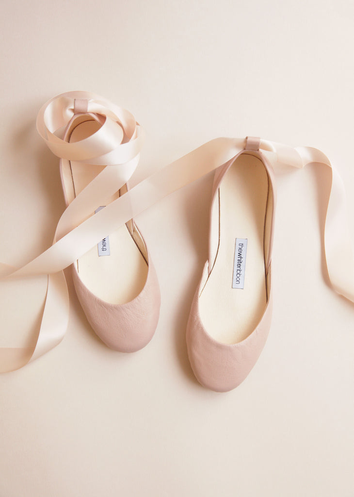 white ballet shoes with ribbon