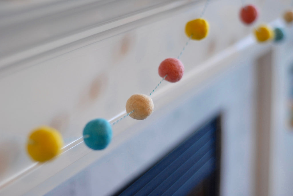 Felted Pom Pom Garland Hanging from Mantle