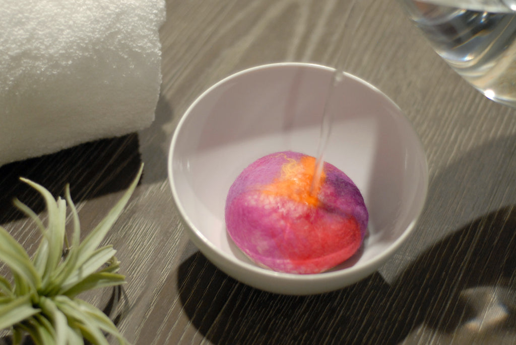 Felted soap in bowl of water