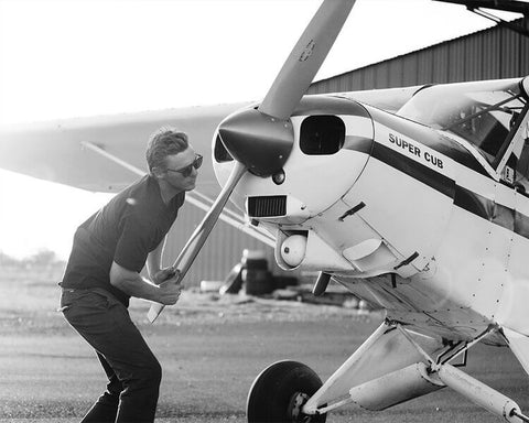 Man inspecting plane propeller