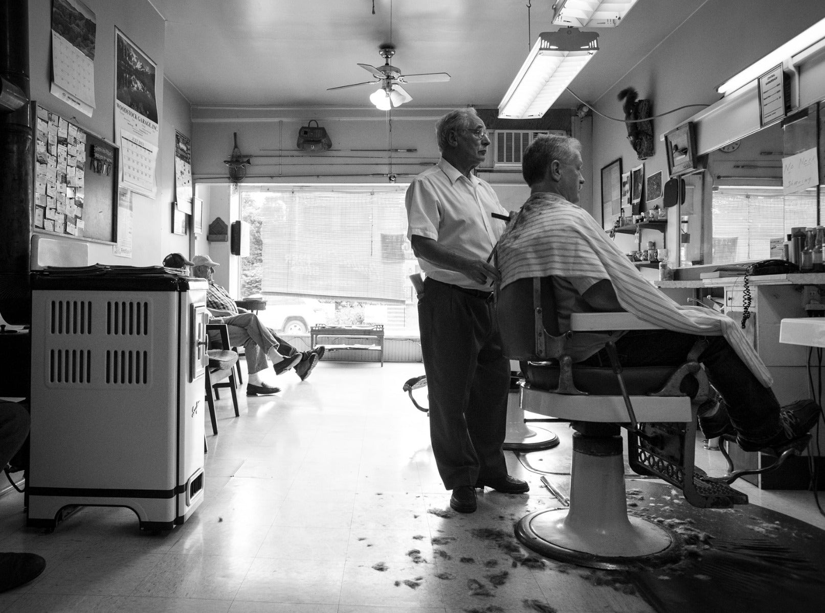 Man getting a haircut in a barbershop with barber