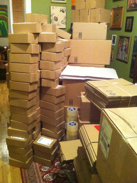 Stacks of boxes of Bees Knees Spicy Honey and shipping supplies