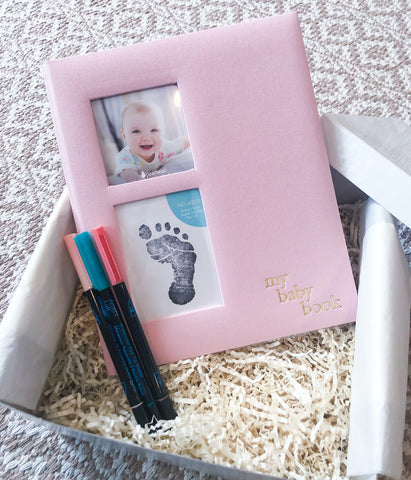 Idea for a new baby gift: wrap up a baby keepsake book with some markers and pens for new parents to use while filling out baby's memory book!