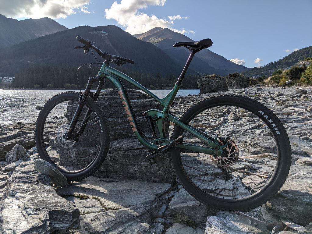 Max's bike shown in front of lake with mountains behind